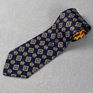 Vintage Tommy Hilfiger men’s necktie with navy medallion / crest pattern.